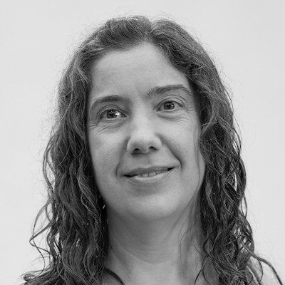 A black and white close-up of a woman with long dark hair.