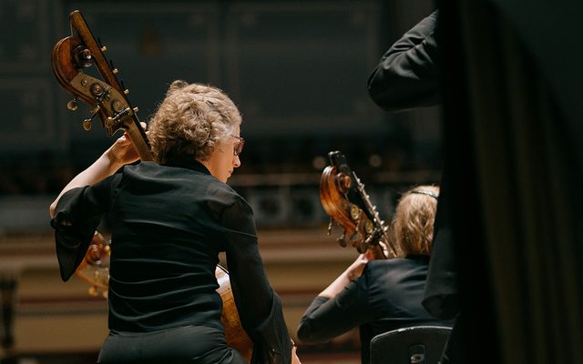 Two cellists performing on stage