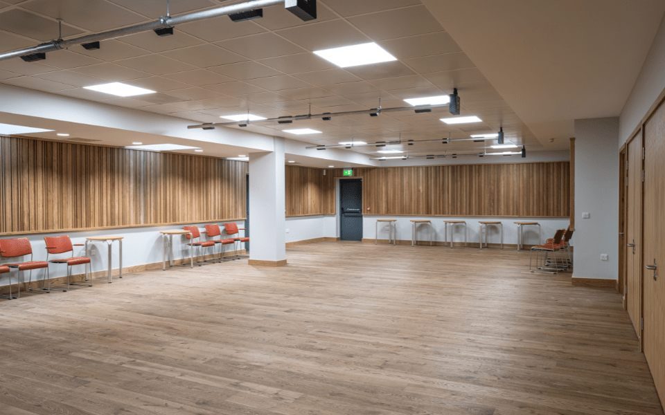 The inside of the Bramall Education Suite - a large spacious room with wood panels and floor, designed for excellent acoustic properties.