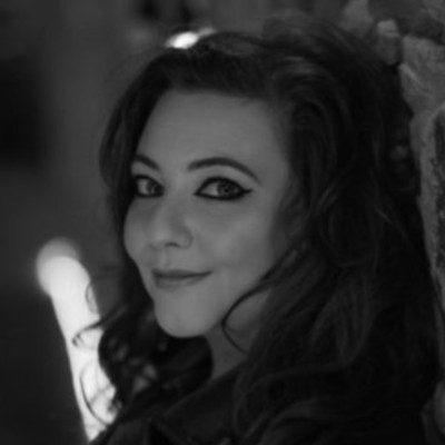 A black and white portrait of a woman with long dark hair.