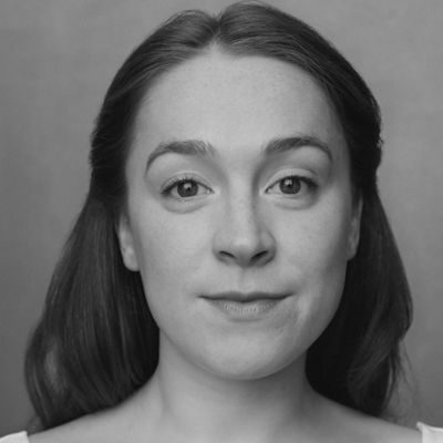 A close-up black and white portrait of a woman with dark blonde hair.