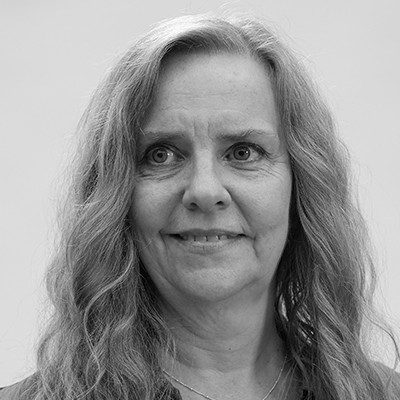 A black and white close-up of a woman with long, light coloured hair.