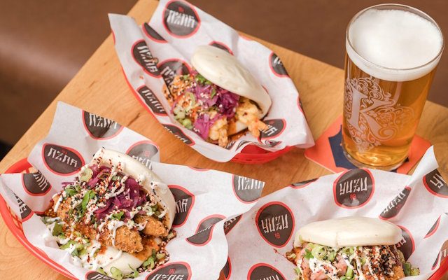 A picture of colourful food next to a pint of beer.