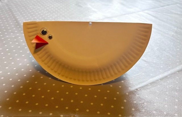 Two googly eyes attached above the beak give the impression of a bird's face.