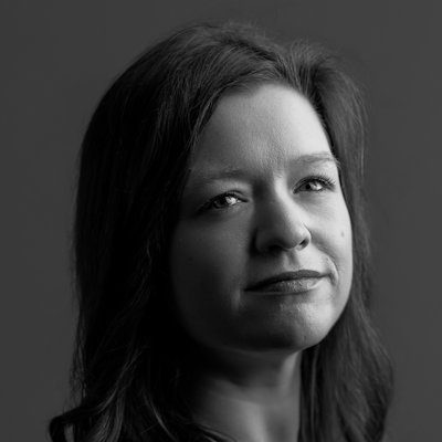 A black and white close-up of a woman with long dark hair.
