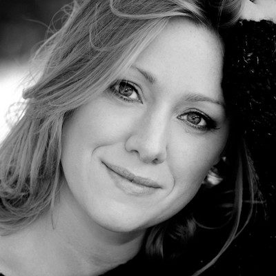 A black and white close-up of a woman with long light hair.
