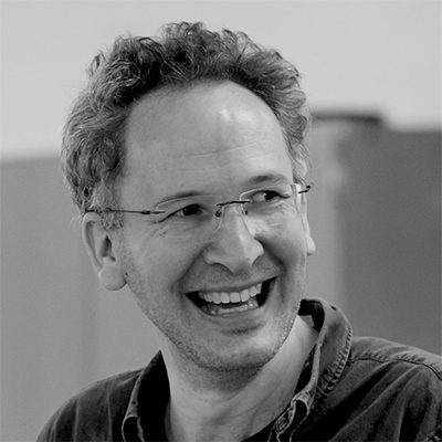 A man wearing glasses and smiling
