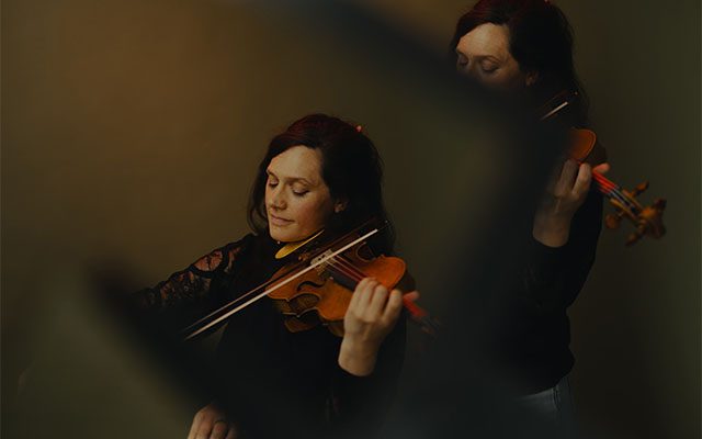 Violonist playing with an athmospheric background