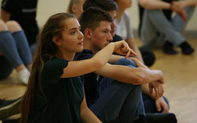 Group of young people sitting in a workshop